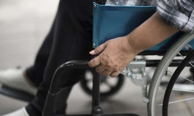 close up senior woman hand wheel wheelchair during walk hospital 1150 4311