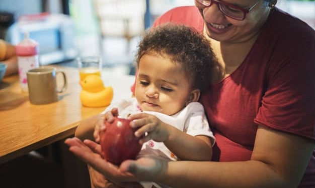 mom letting daughter play with apple 53876 42724