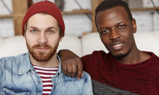 people love homosexuality samesex male couple spending nice time together cafe afro american man holding hand his caucasian partner s shoulder both looking smiling 273609 109