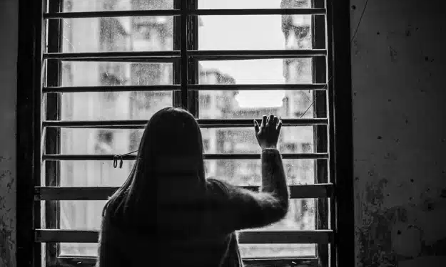 rear view sad woman window 1205 296.jpg