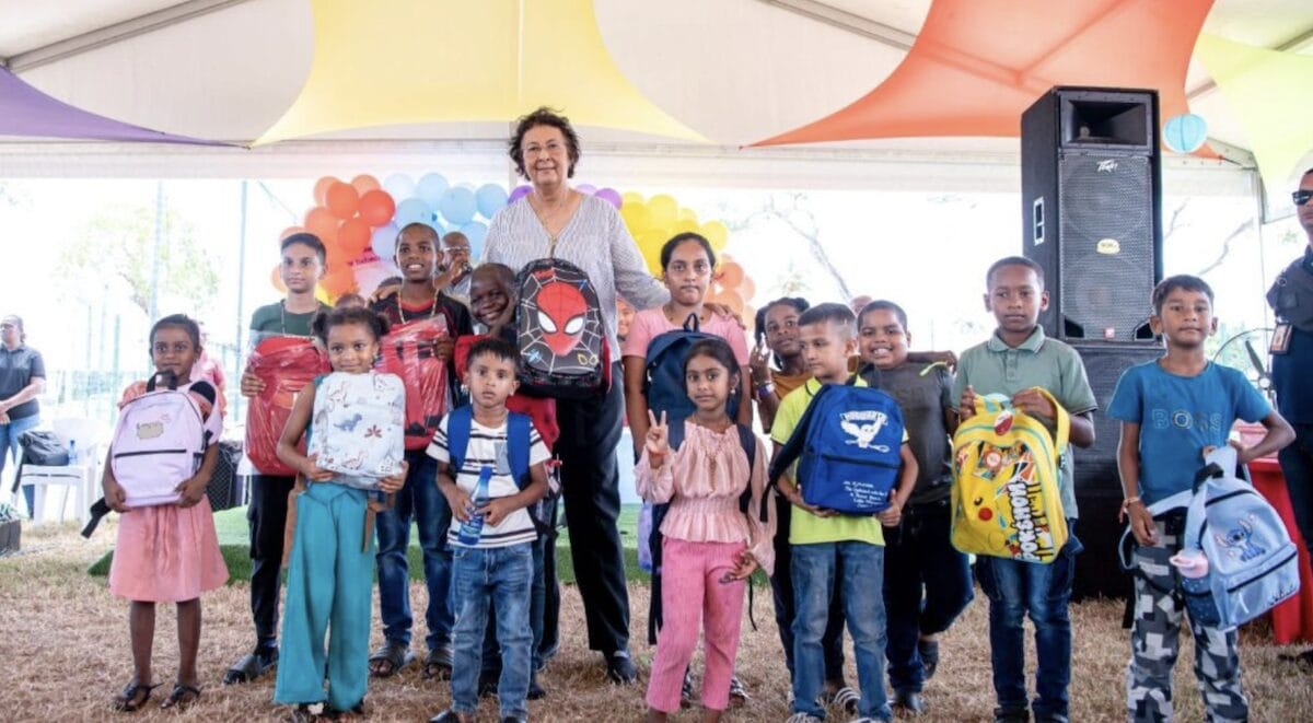 President Jennifer Simons overhandigt in Nieuw Nickerie een schoolpakket aan een van de kinderen die voor het initiatief in aanmerking kwamen. Foto: CDS